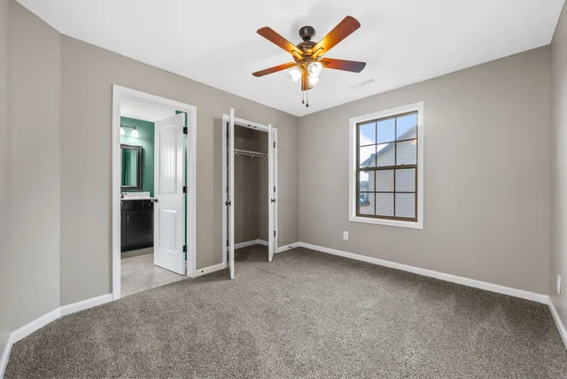 an empty room with windows and closet