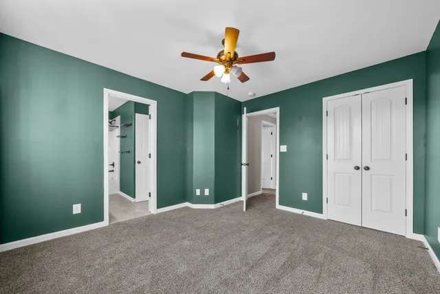 a view of a livingroom with a ceiling fan and window