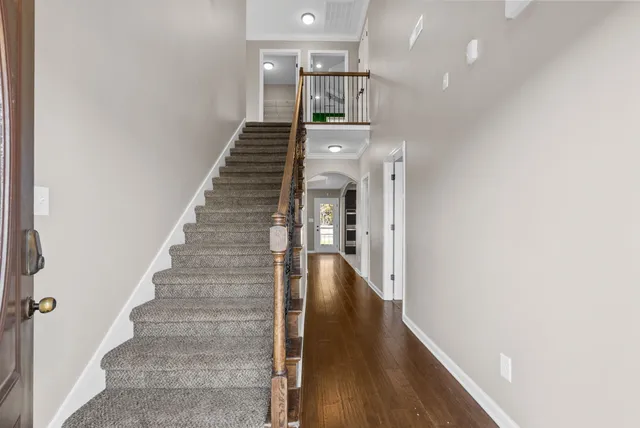 a view of entryway and hall with wooden floor