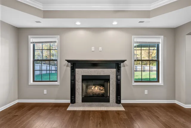 a living room with a fireplace and wooden floor