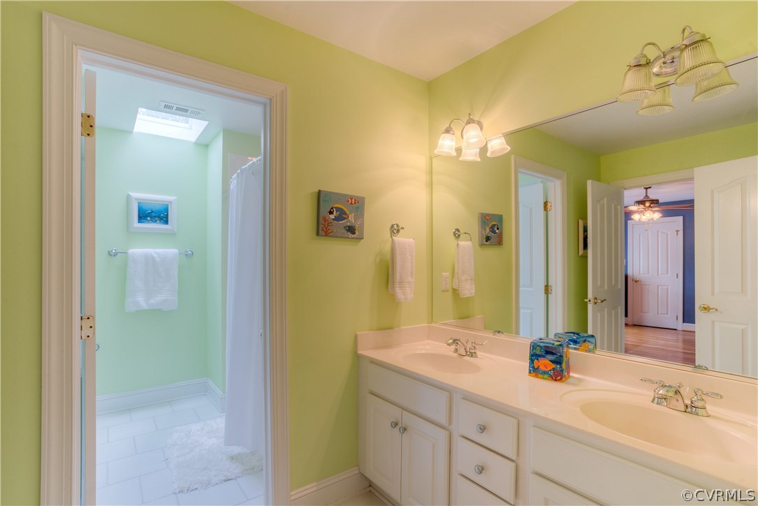 3613 Salles Ridge Court Midlothian, VA 23113 - Photo 28 of 36 a bathroom with a double vanity sink and a mirror
