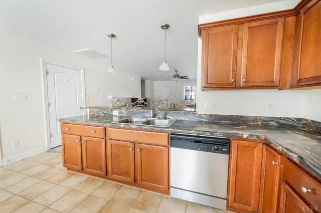 a kitchen with stainless steel appliances granite countertop a sink a stove and cabinets