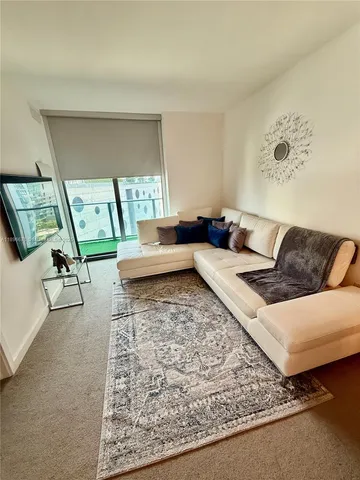 a living room with furniture and a rug