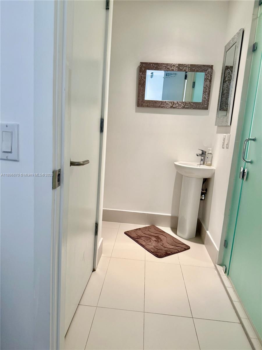 501 Northeast 31st Street, Unit 602 Miami, FL 33137 - Photo 12 of 38 a bathroom with a sink and glass door