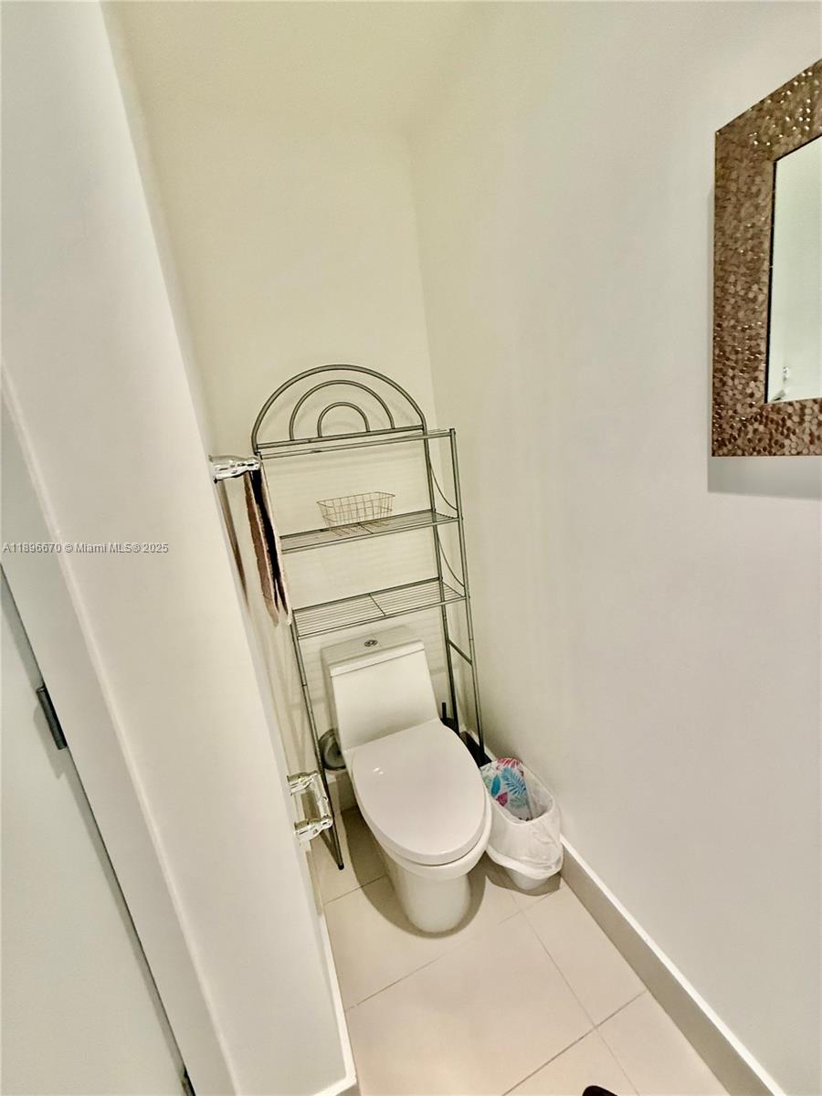 501 Northeast 31st Street, Unit 602 Miami, FL 33137 - Photo 14 of 38 a bathroom with a toilet and a mirror