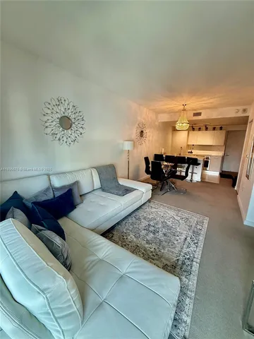 a living room with furniture and a piano