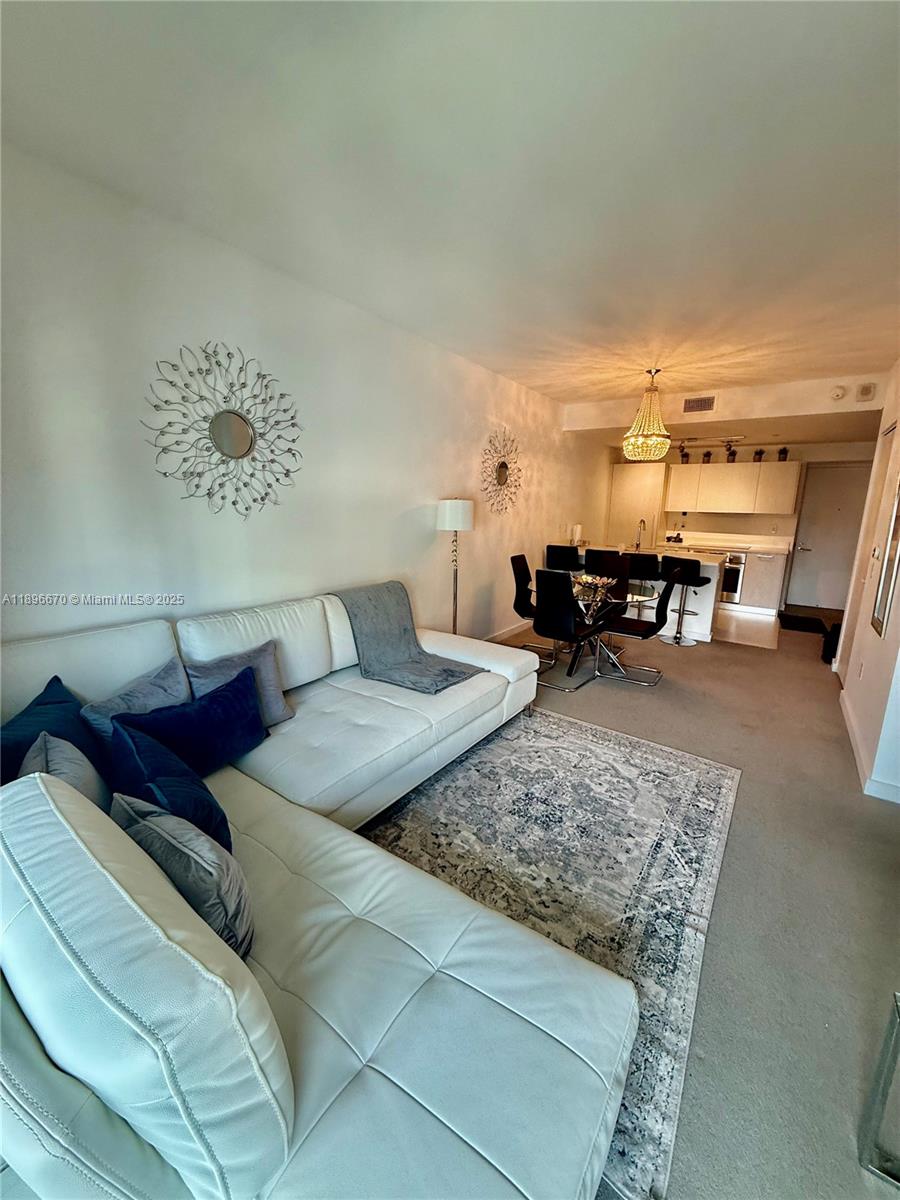 501 Northeast 31st Street, Unit 602 Miami, FL 33137 - Photo 2 of 38 a living room with furniture and a piano