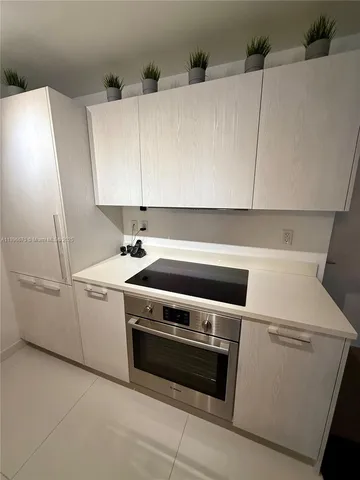 a kitchen with stainless steel appliances granite countertop a sink and a stove