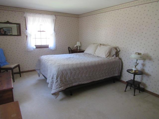 1 Keith Road Pocasset, MA 02559 - Photo 13 of 25 a bed sitting in a bedroom next to a window
