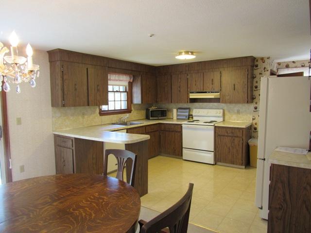 1 Keith Road Pocasset, MA 02559 - Photo 8 of 25 a kitchen with kitchen island a sink a stove a counter top space and cabinets