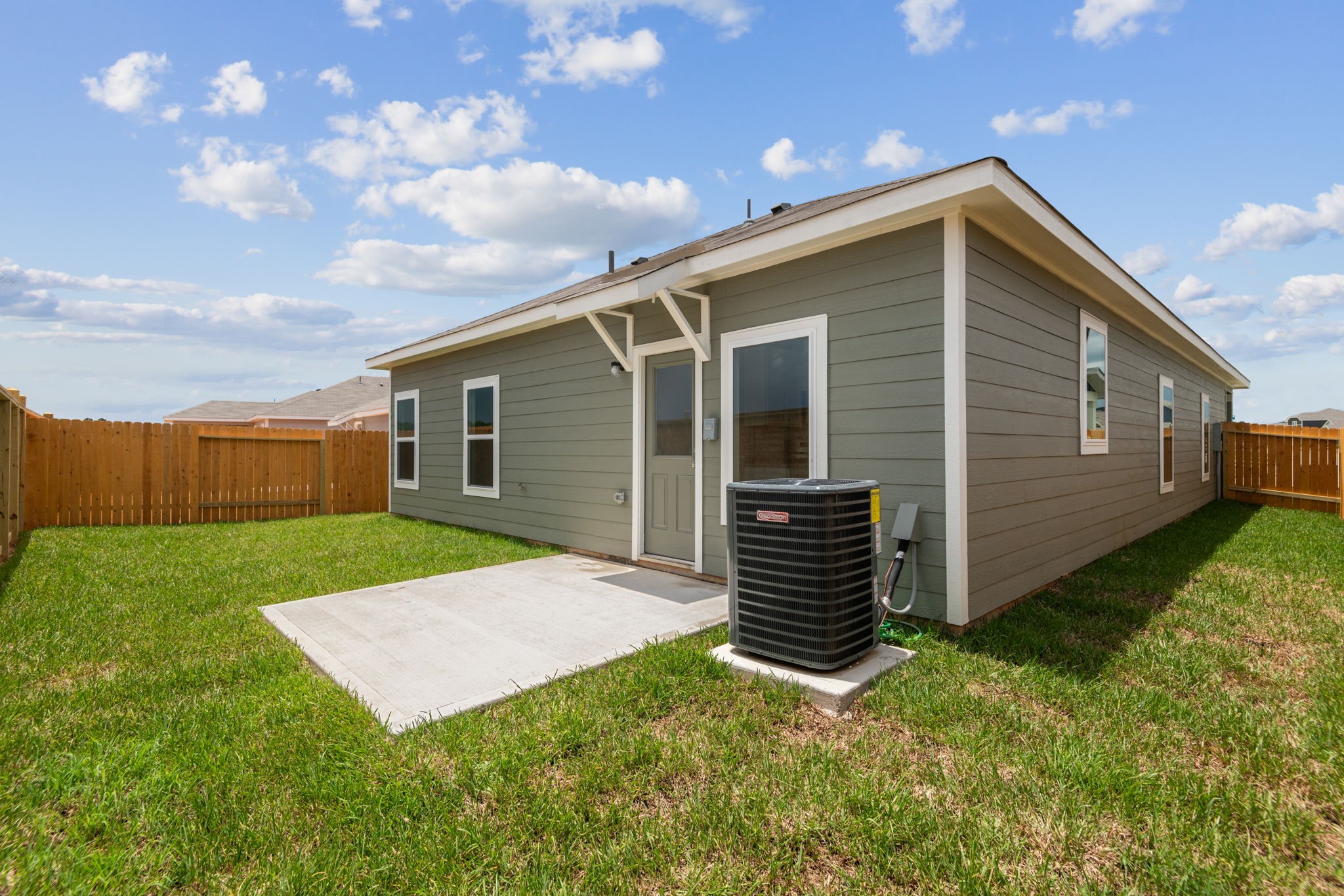 15542 Caramel Spgs Drive Conroe, TX 77303 - Photo 2 of 23 a view of backyard with barbeque grill potted plants and wooden fence