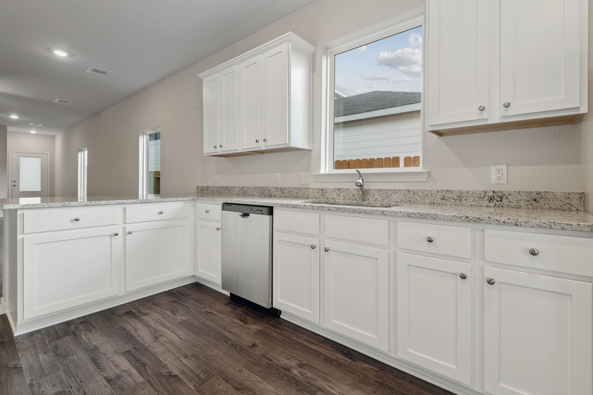 15542 Caramel Spgs Drive Conroe, TX 77303 - Photo 7 of 23 a kitchen with granite countertop white cabinets and white appliances