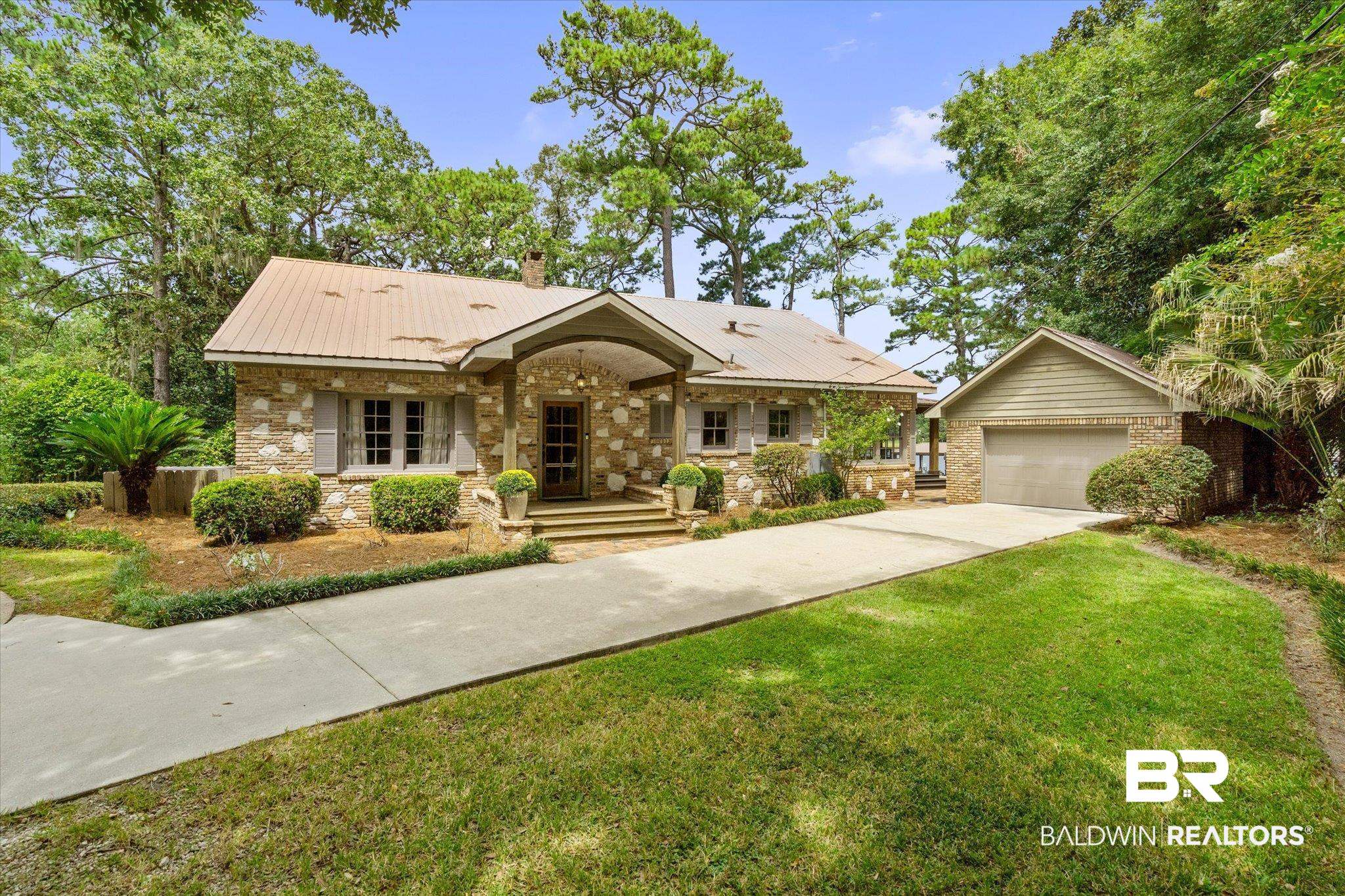 2228 Riverside Drive Mobile, AL 36605 - Photo 2 of 51 Ranch-style home with a garage, covered porch, a front lawn, and an outdoor structure