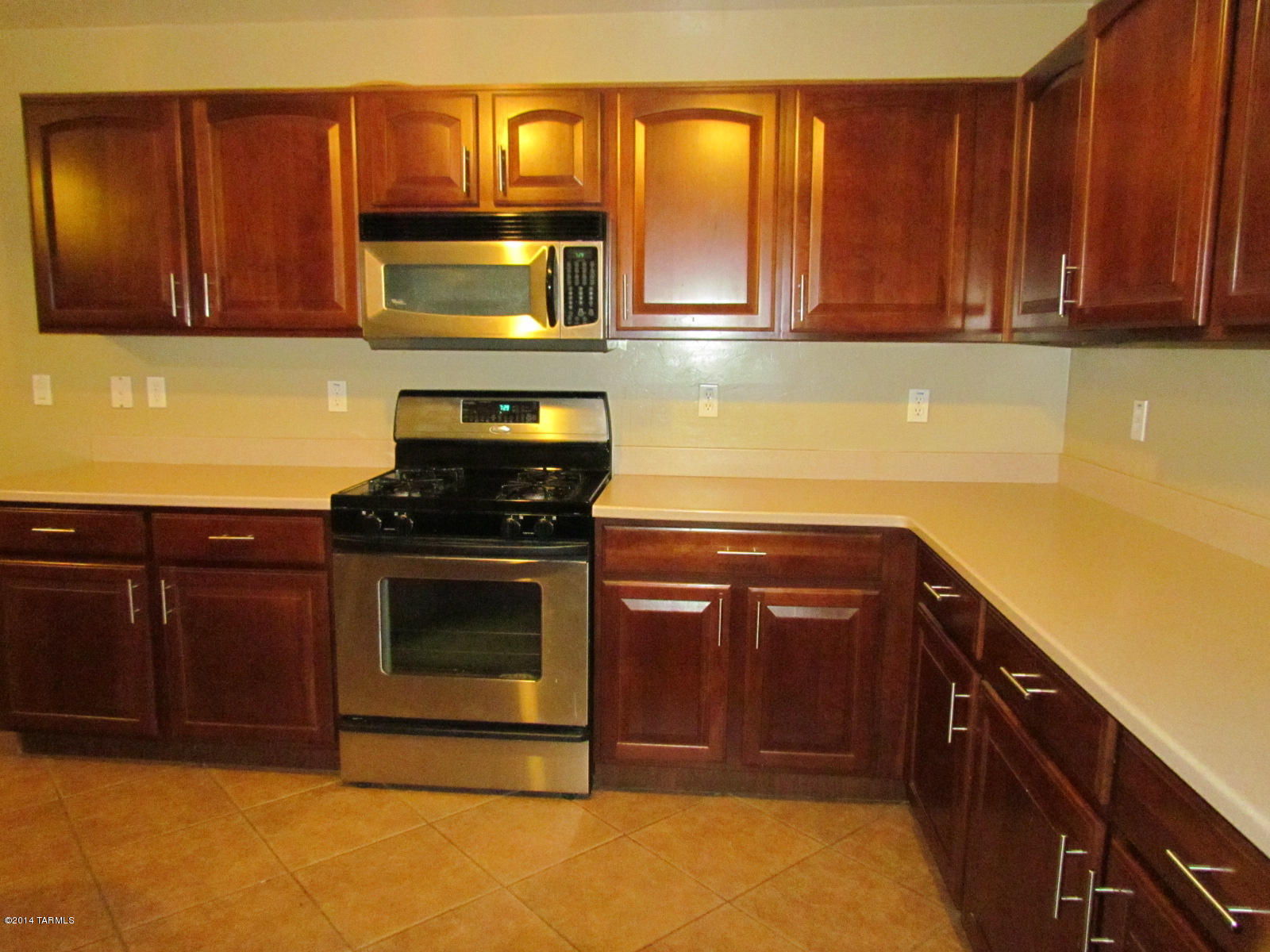 669 West Ash Ridge Drive Green Valley, AZ 85614 - Photo 4 of 17 a kitchen with granite countertop wood cabinets and stainless steel appliances