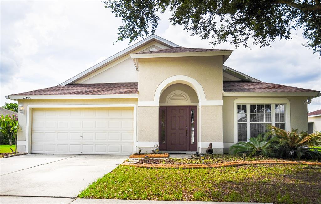 12424 Cedarfield Drive Riverview, FL 33579 - Photo 1 of 1 a front view of a house with a yard