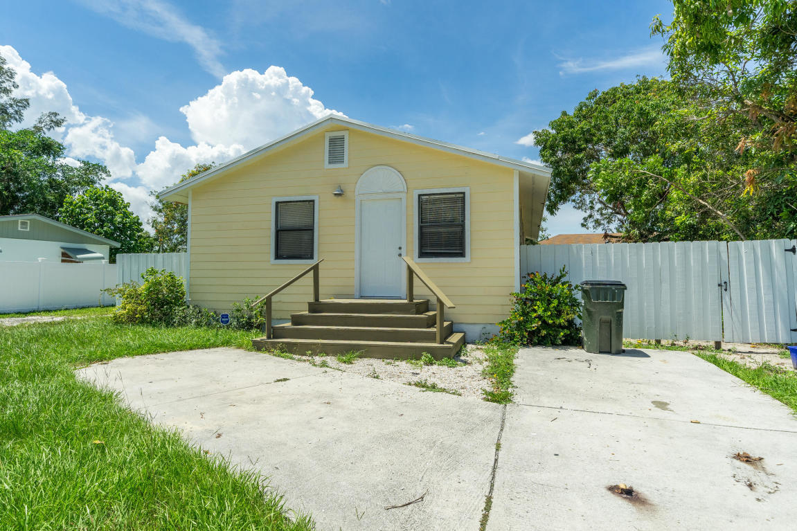 507 Northwest 3rd Street Delray Beach, FL 33444 - Photo 1 of 30 a front view of a house with garden