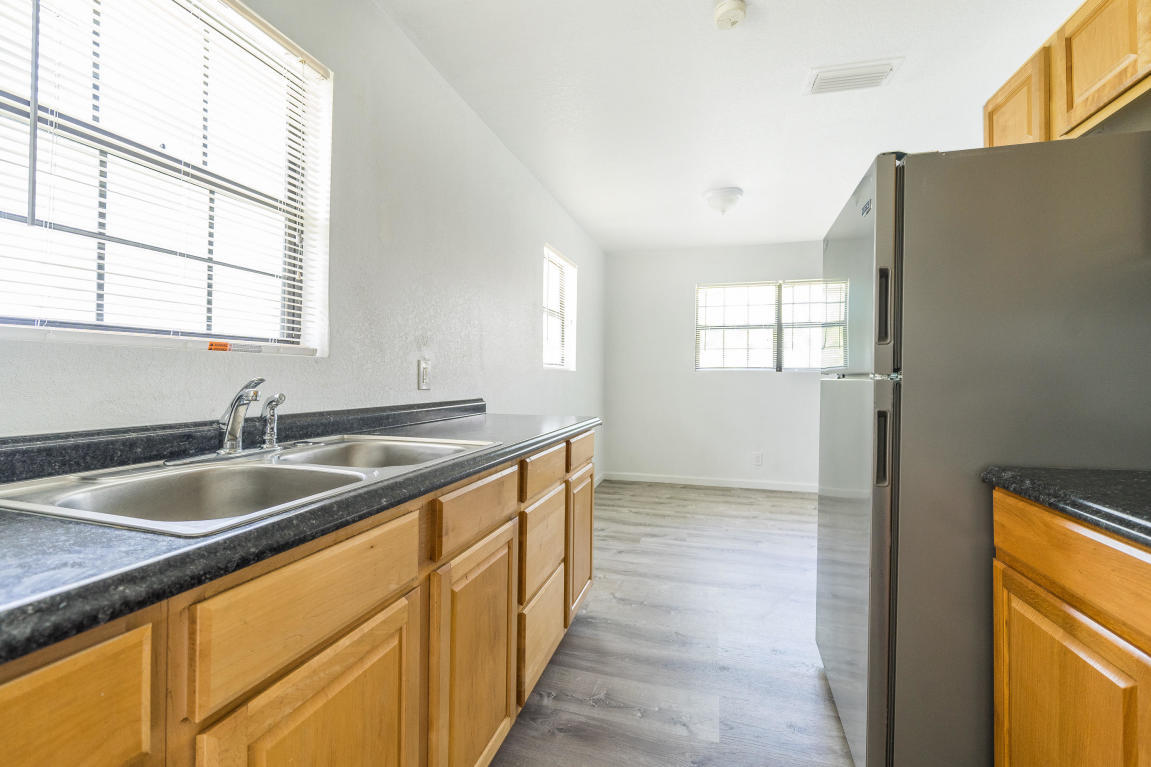 507 Northwest 3rd Street Delray Beach, FL 33444 - Photo 12 of 30 a kitchen with granite countertop a sink and a window