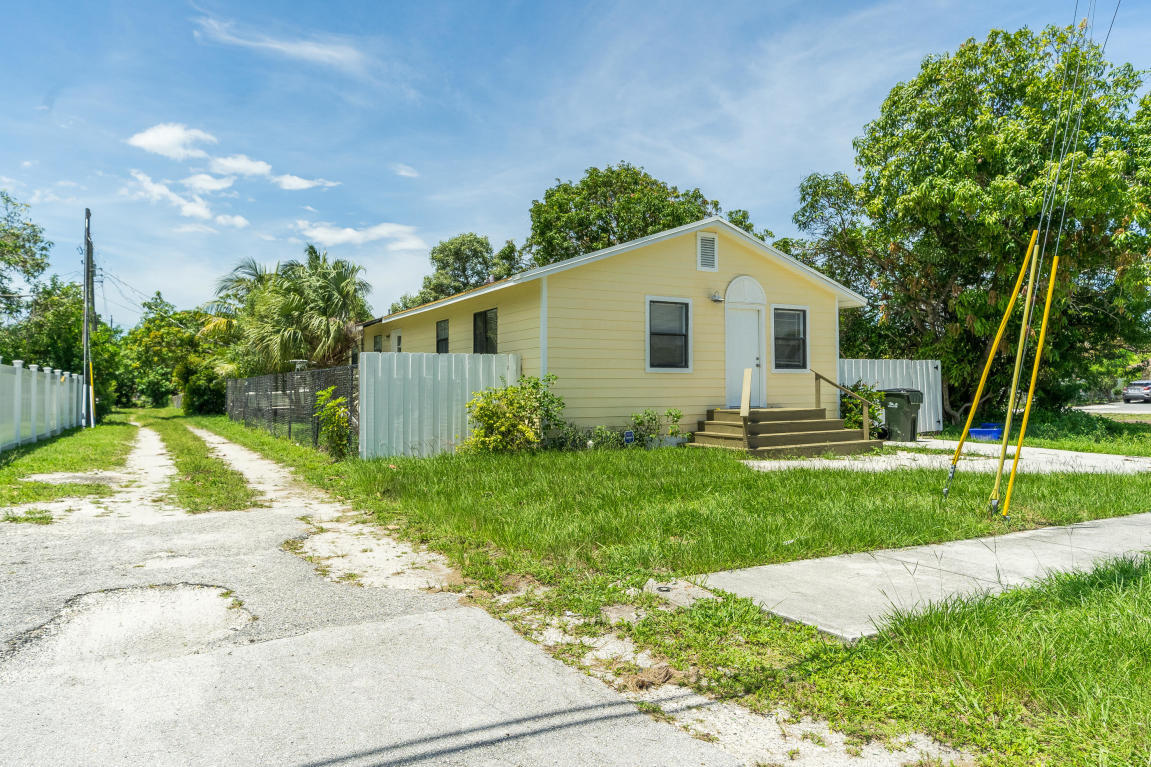 507 Northwest 3rd Street Delray Beach, FL 33444 - Photo 2 of 30 a front view of a house with a yard