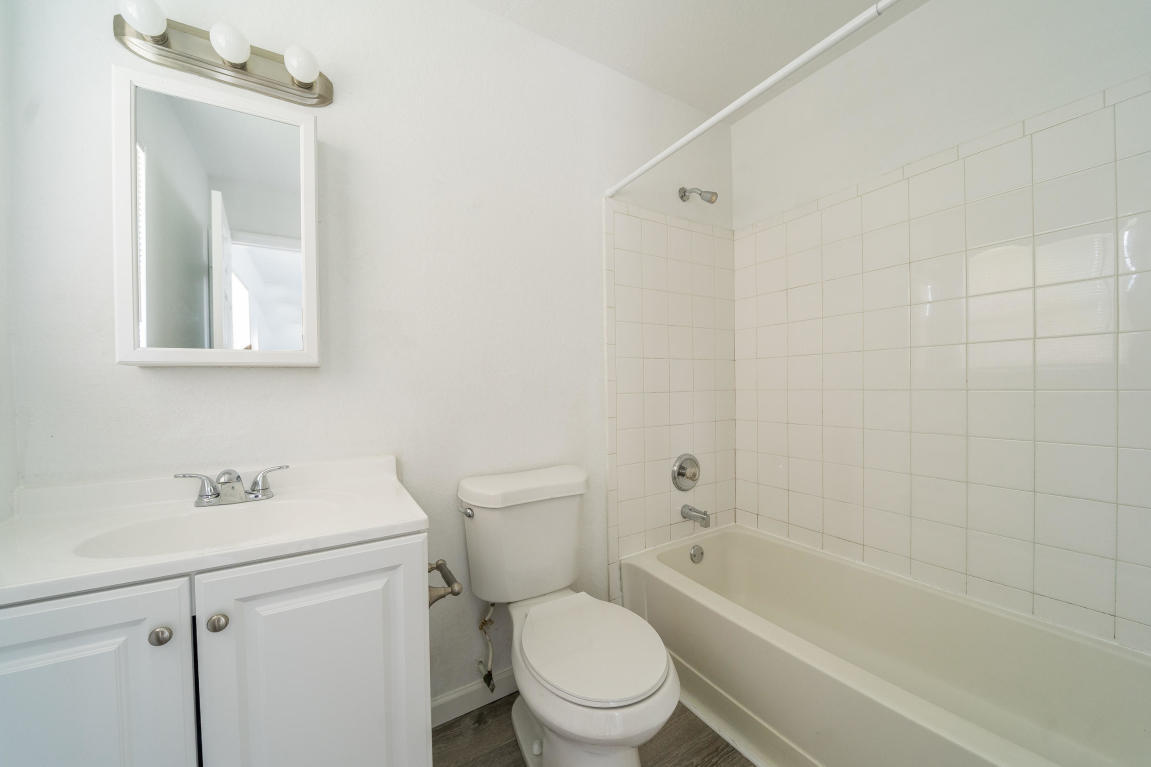 507 Northwest 3rd Street Delray Beach, FL 33444 - Photo 25 of 30 a white toilet sitting next to a bath tub