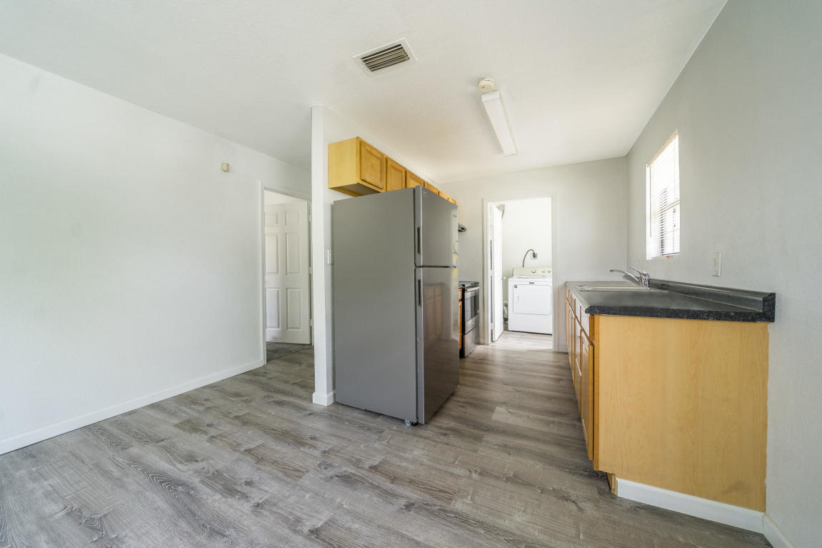 507 Northwest 3rd Street Delray Beach, FL 33444 - Photo 5 of 30 a view of a kitchen with a refrigerator and a stove top oven