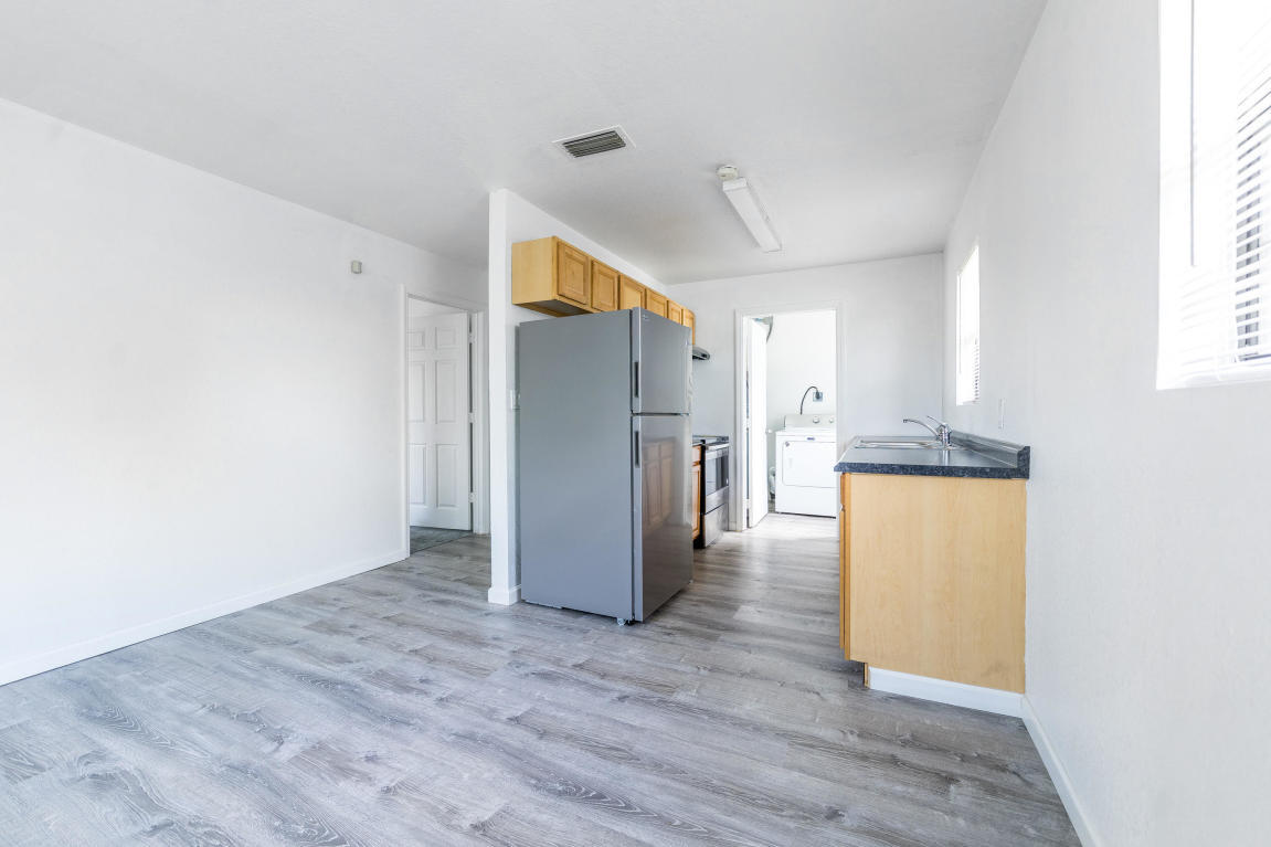 507 Northwest 3rd Street Delray Beach, FL 33444 - Photo 6 of 30 a view of a kitchen with a refrigerator a microwave and a stove top oven