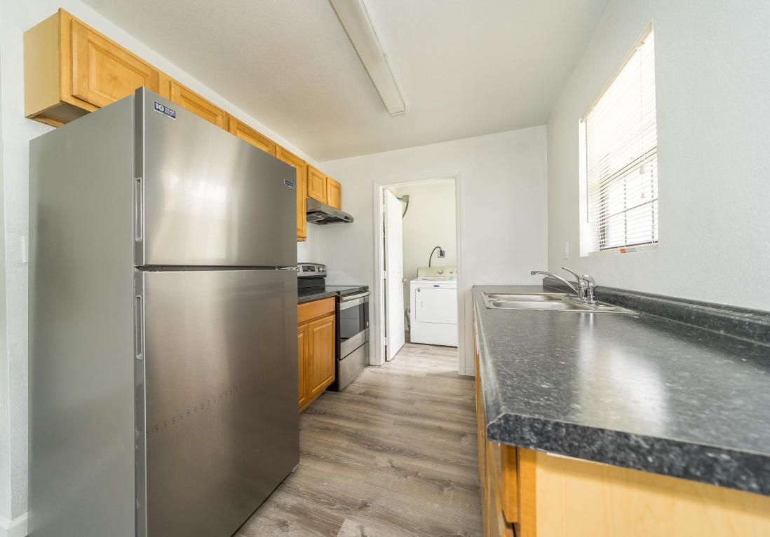 507 Northwest 3rd Street Delray Beach, FL 33444 - Photo 8 of 30 a kitchen with stainless steel appliances granite countertop a refrigerator a stove and a sink with large window