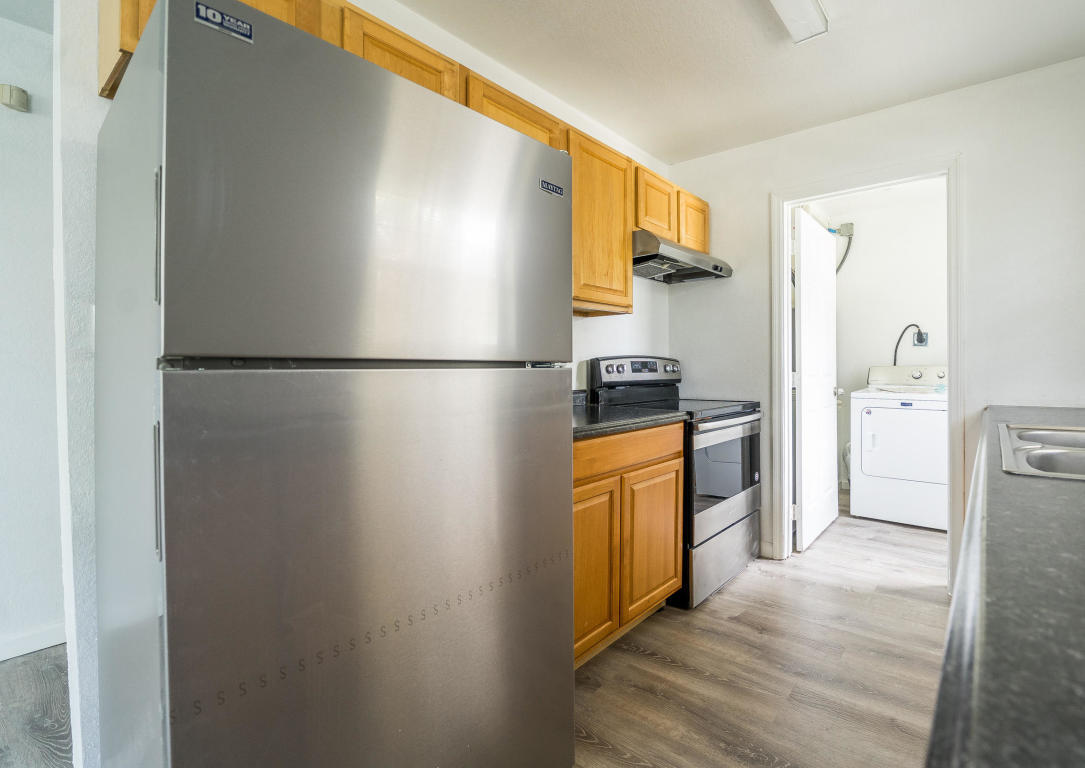 507 Northwest 3rd Street Delray Beach, FL 33444 - Photo 9 of 30 a kitchen with stainless steel appliances a refrigerator and a stove top oven