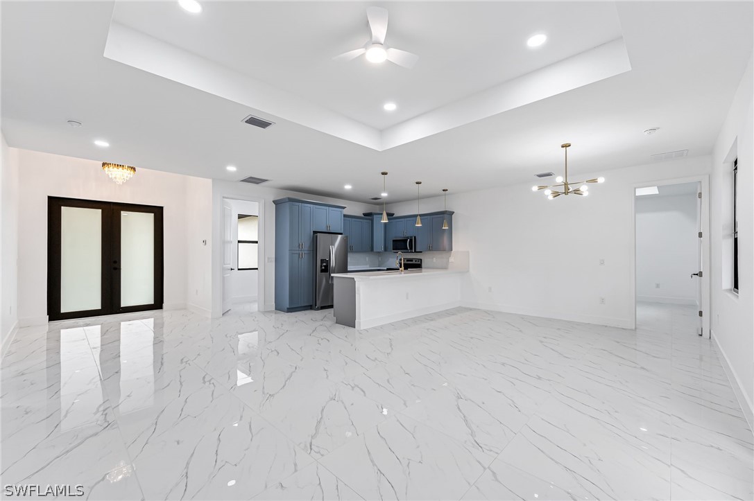 1519 Meadow Road Lehigh Acres, FL 33976 - Photo 5 of 32 a view of a kitchen with a sink and a refrigerator