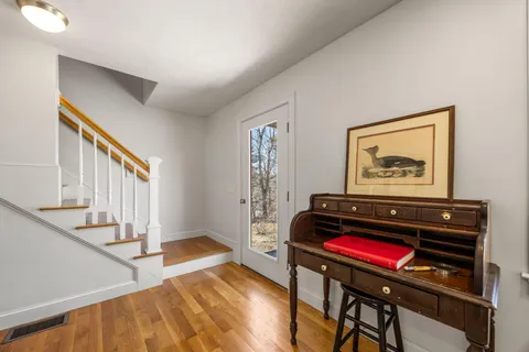 a living room with furniture gaming equipment and a flat screen tv