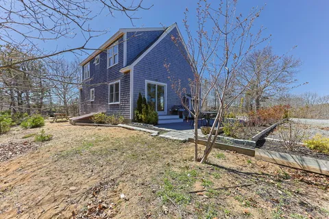 a view of a house with a yard and sitting area
