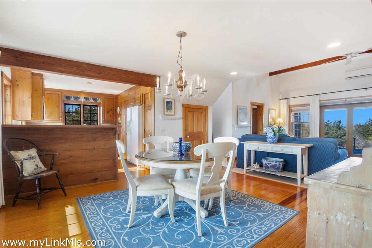 13 Eat Fire Spring Road Nantucket, MA 02554 - Photo 14 of 43 a dining room with furniture a rug and a chandelier