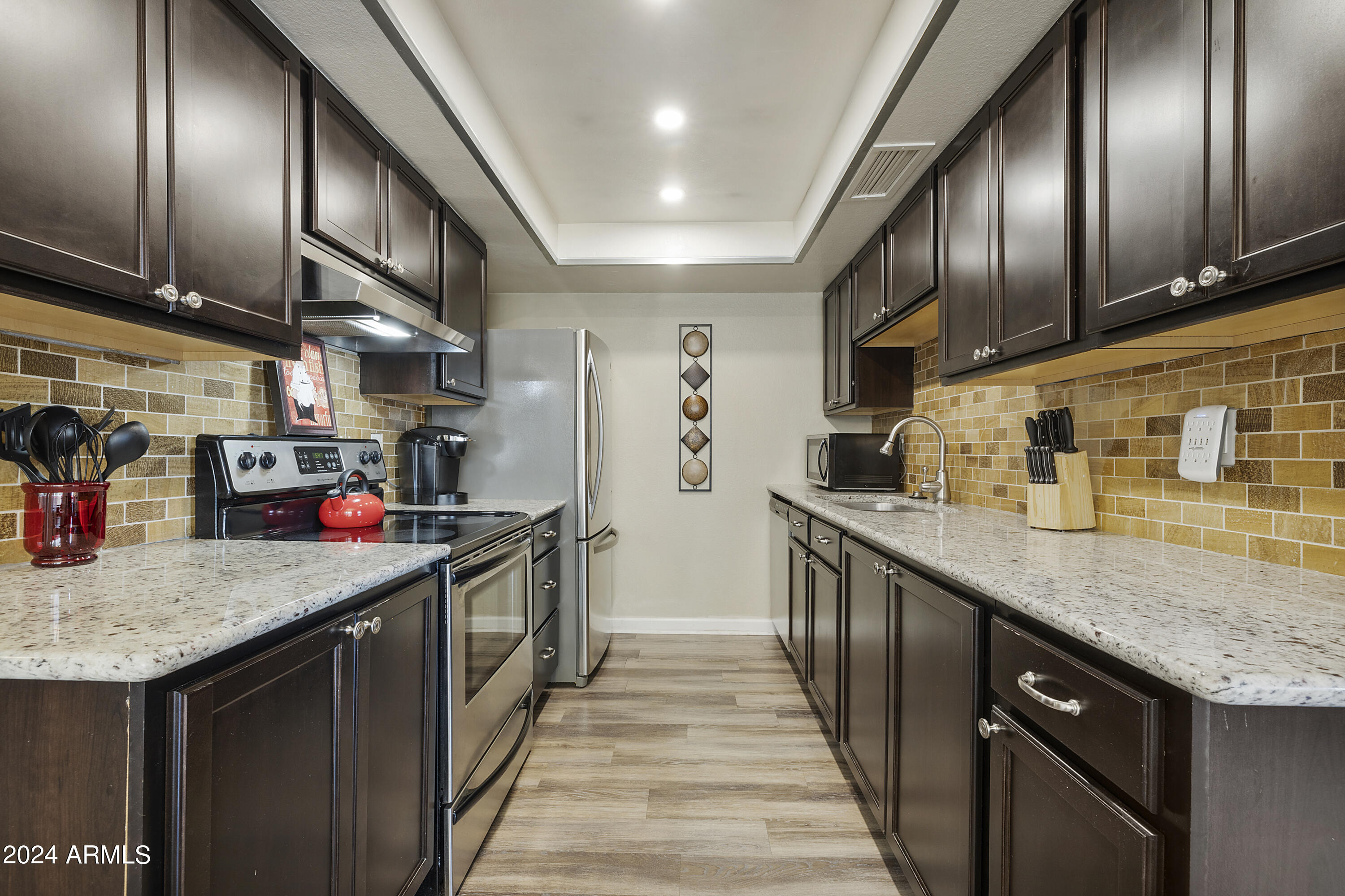 1223 North Granite Reef Road Scottsdale, AZ 85257 - Photo 13 of 35 a kitchen with stainless steel appliances granite countertop lots of counter top space