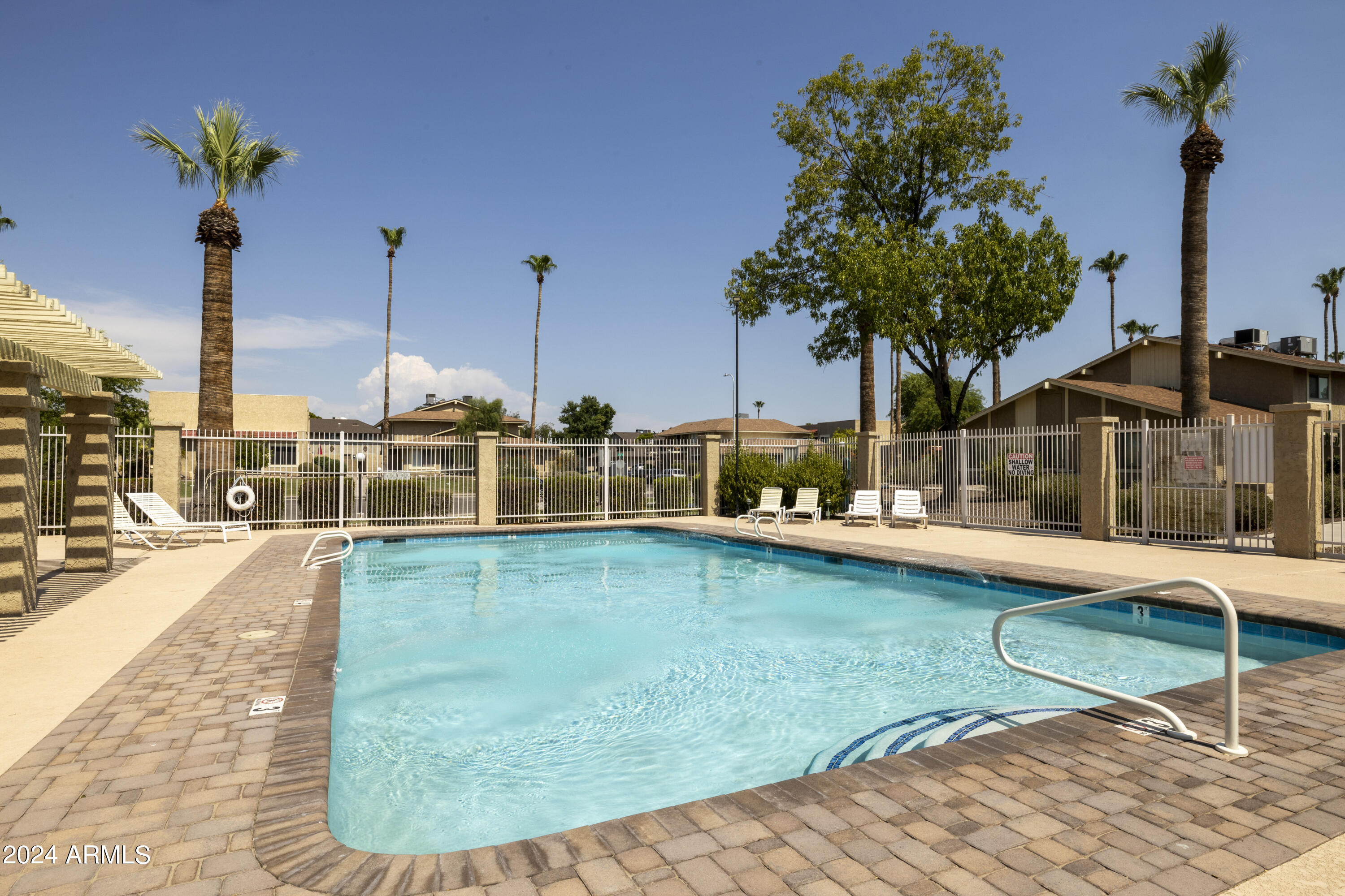 1223 North Granite Reef Road Scottsdale, AZ 85257 - Photo 32 of 35 a view of a swimming pool with a yard and palm trees