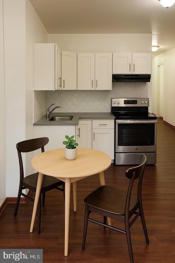 6041 Vine Street Philadelphia, PA 19139 - Photo 1 of 10 a kitchen with a stove a sink and a refrigerator