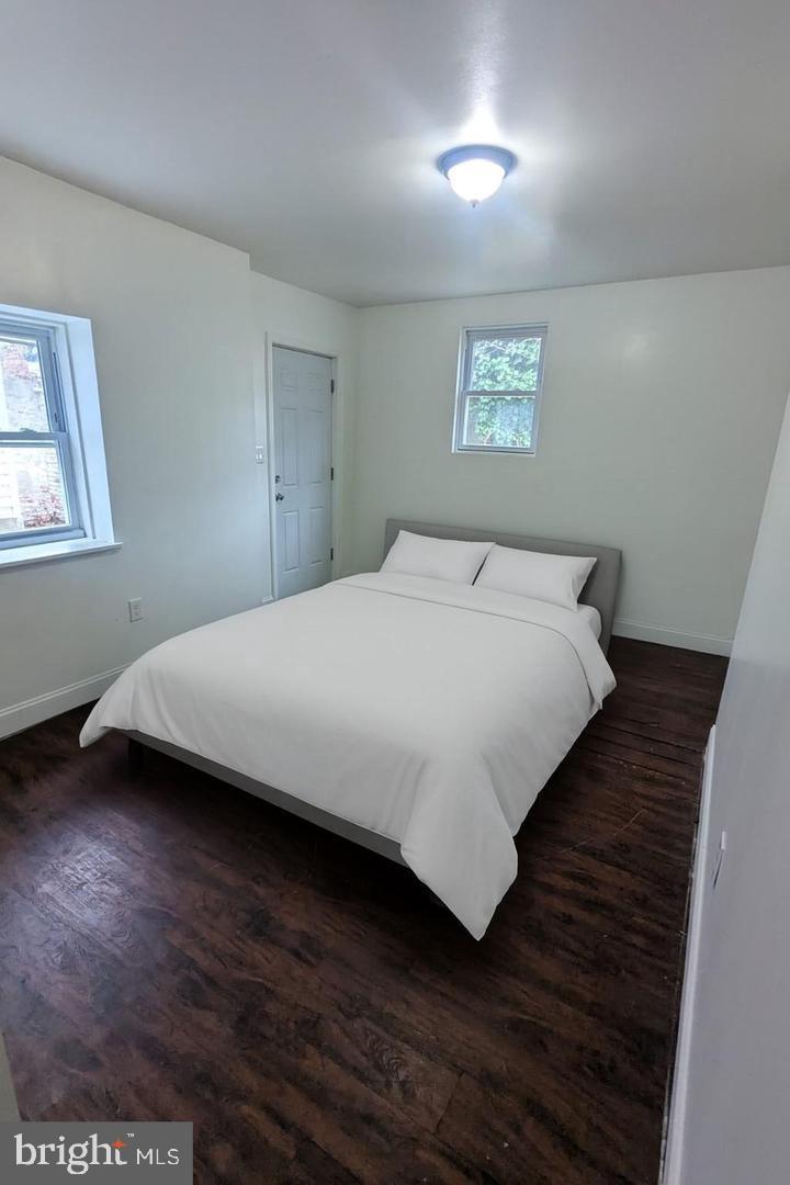 6041 Vine Street Philadelphia, PA 19139 - Photo 5 of 10 a bedroom with a bed and a night stand