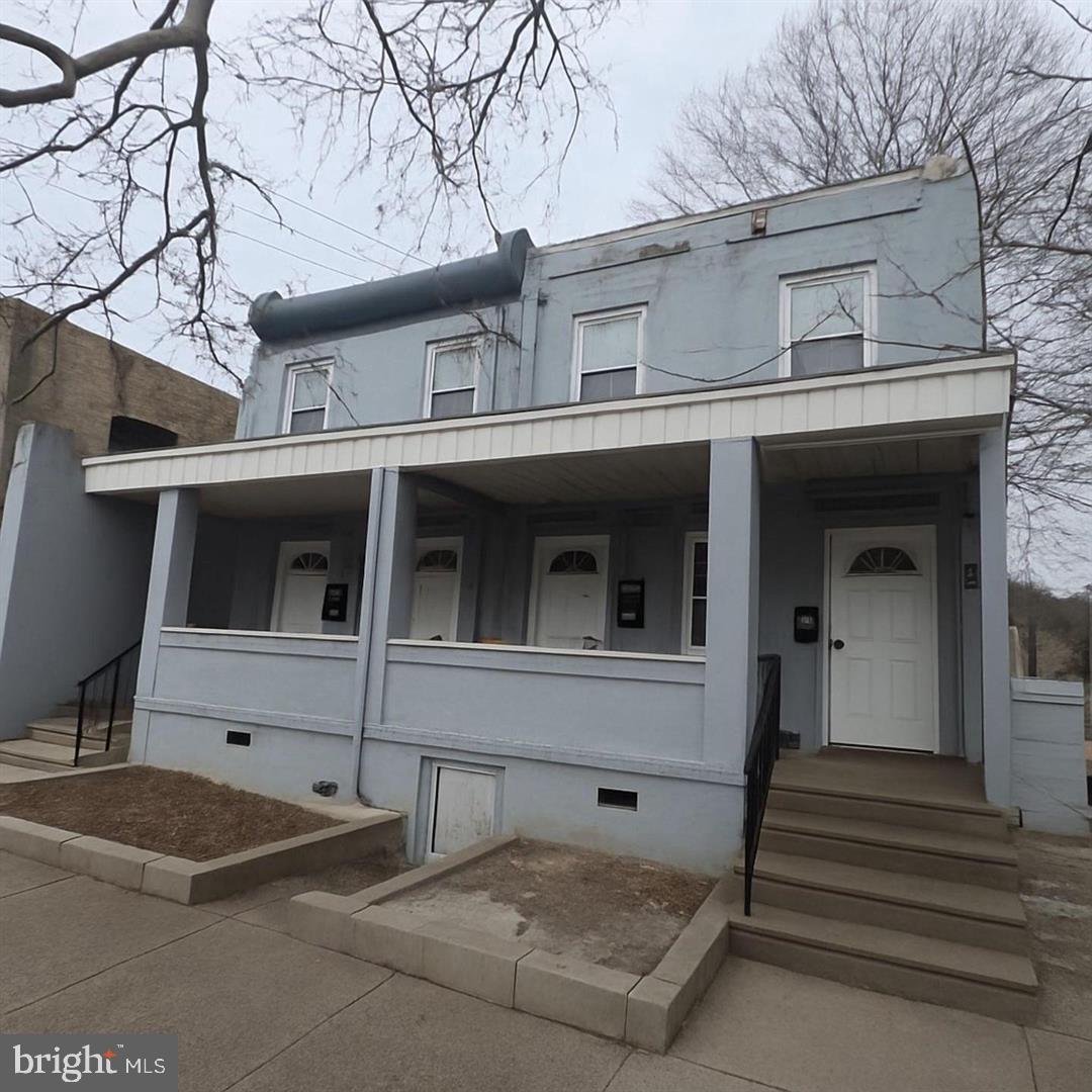 6041 Vine Street Philadelphia, PA 19139 - Photo 7 of 10 a view of a white house with large windows and a tree