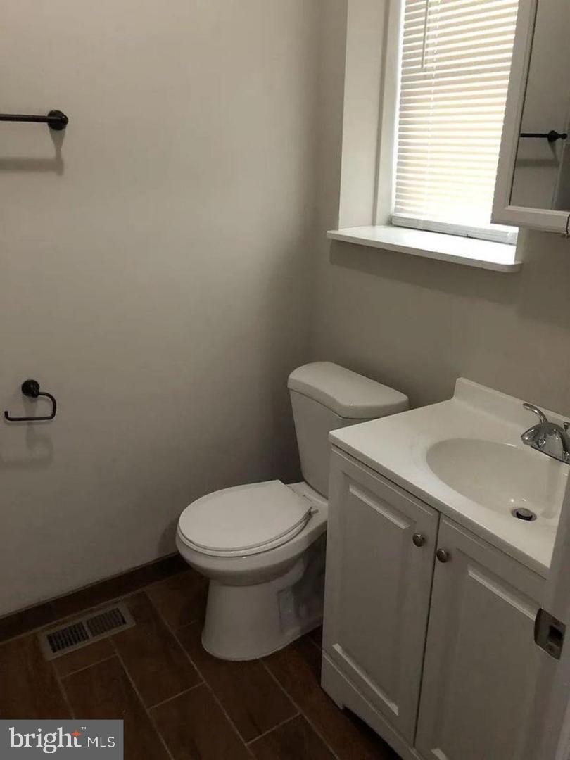 6041 Vine Street Philadelphia, PA 19139 - Photo 9 of 10 a bathroom with a sink toilet and a window