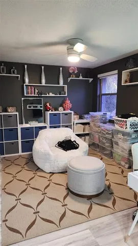 a room with table chairs and a flat screen tv