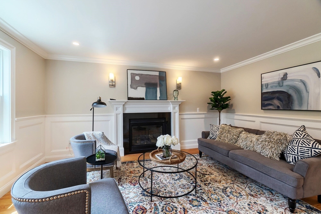 269 Dale Street, Unit 1 Waltham, MA 02451 - Photo 15 of 42 a living room with furniture and a fireplace