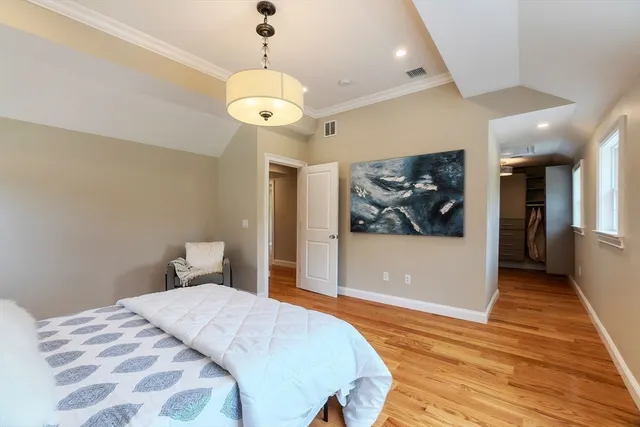 a bedroom with a bed and a chandelier