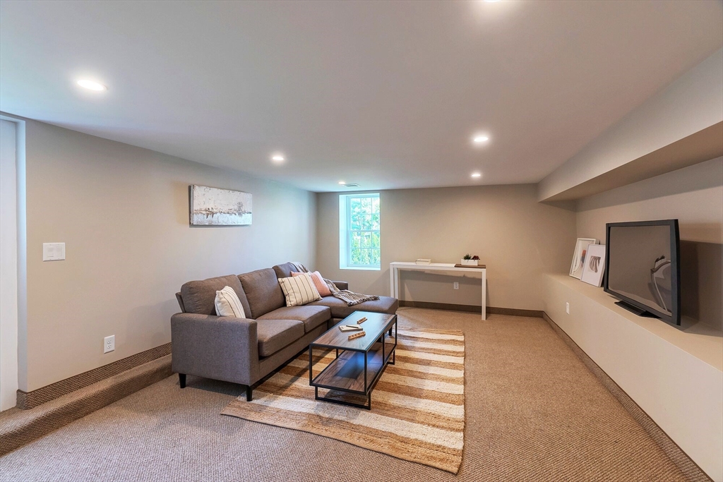 269 Dale Street, Unit 1 Waltham, MA 02451 - Photo 30 of 42 a living room with furniture and a flat screen tv