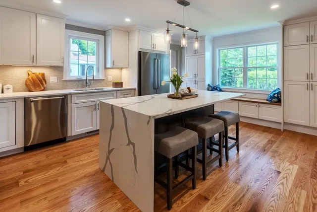 a kitchen with a table chairs sink and cabinets