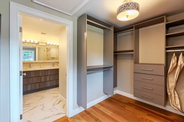 a view of walk in closet and bedroom