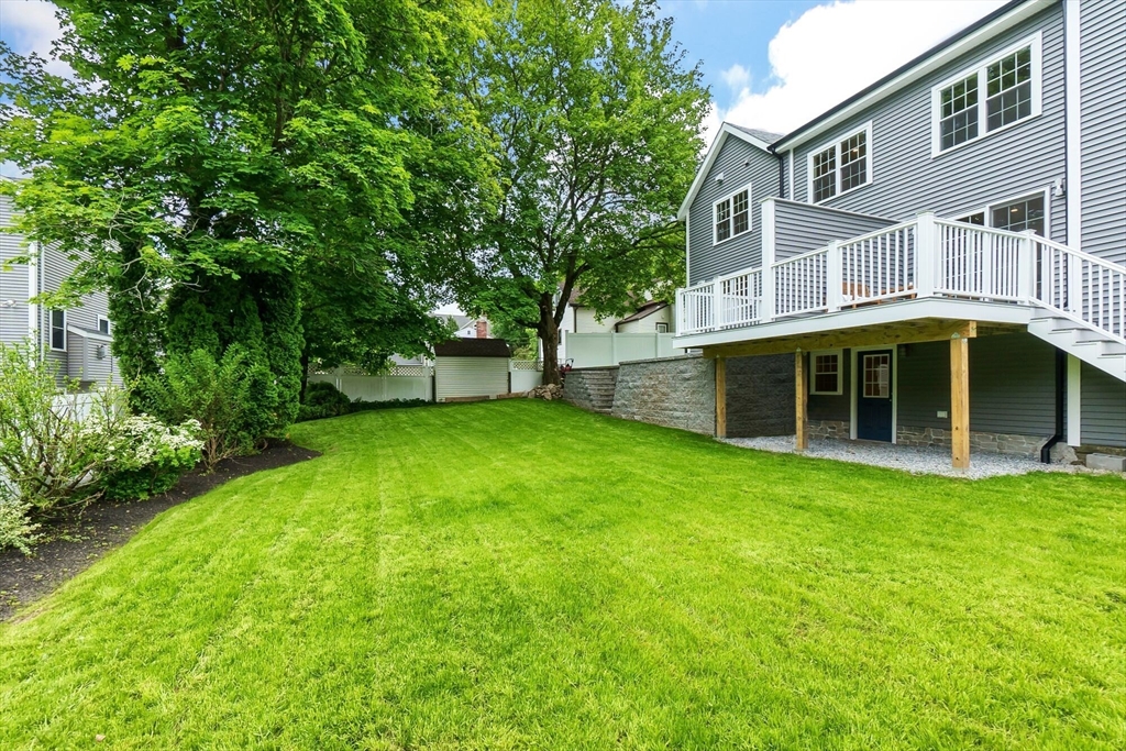 269 Dale Street, Unit 1 Waltham, MA 02451 - Photo 40 of 42 a view of a house with a yard