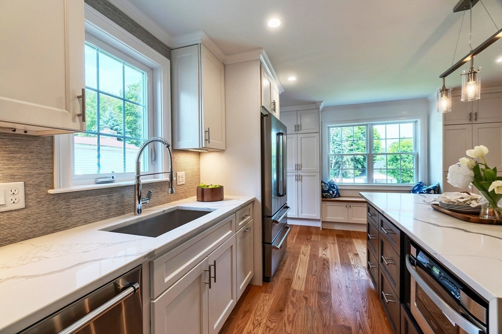 269 Dale Street, Unit 1 Waltham, MA 02451 - Photo 5 of 42 a kitchen with stainless steel appliances a sink a stove and a refrigerator
