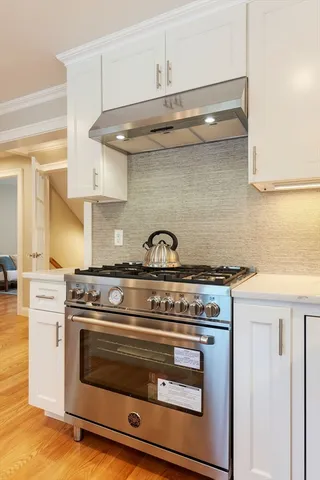 a stove top oven sitting inside of a kitchen