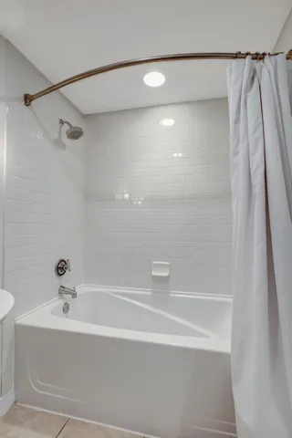 a bathroom with a shower and a bath tub