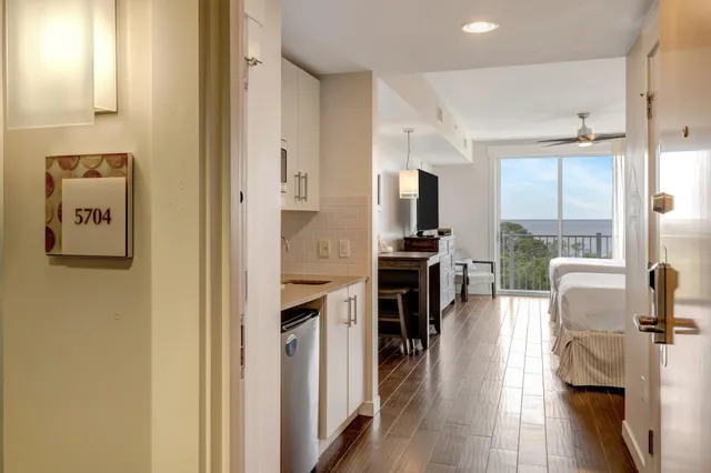 a kitchen with stainless steel appliances a refrigerator and a view of living room
