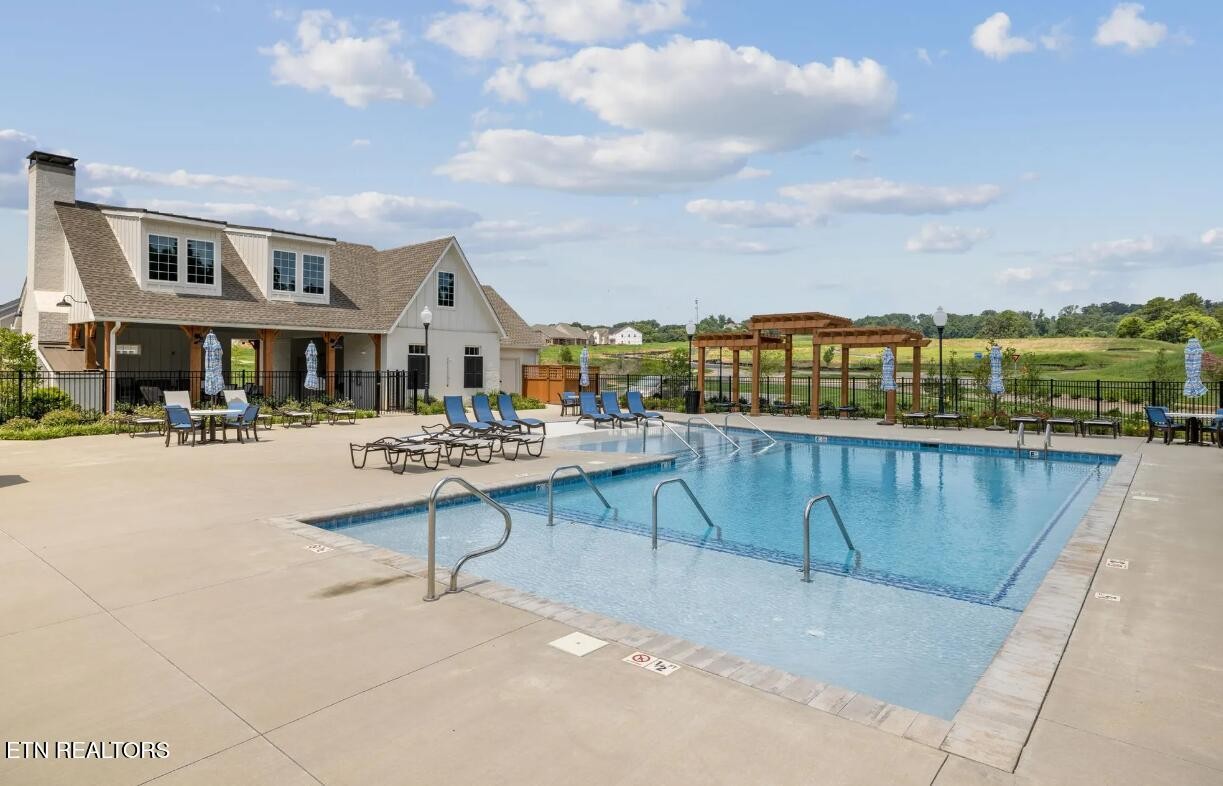 423 Ivey Farms Road Knoxville, TN 37934 - Photo 18 of 20 a view of a lake with a terrace with seating space