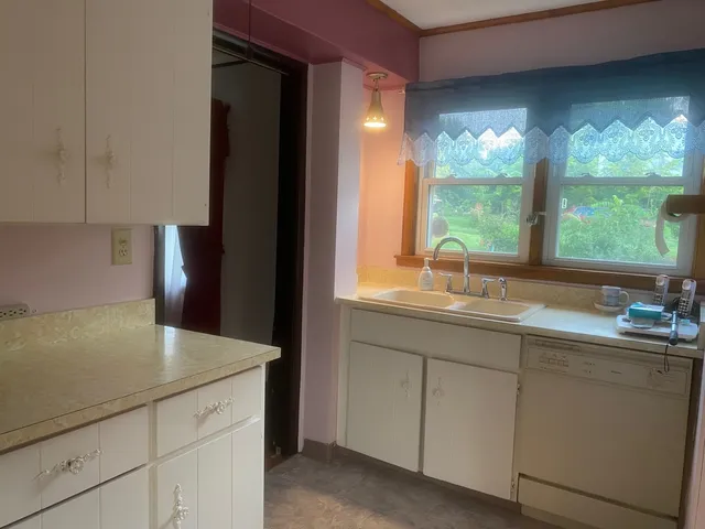 a kitchen with a sink and large window